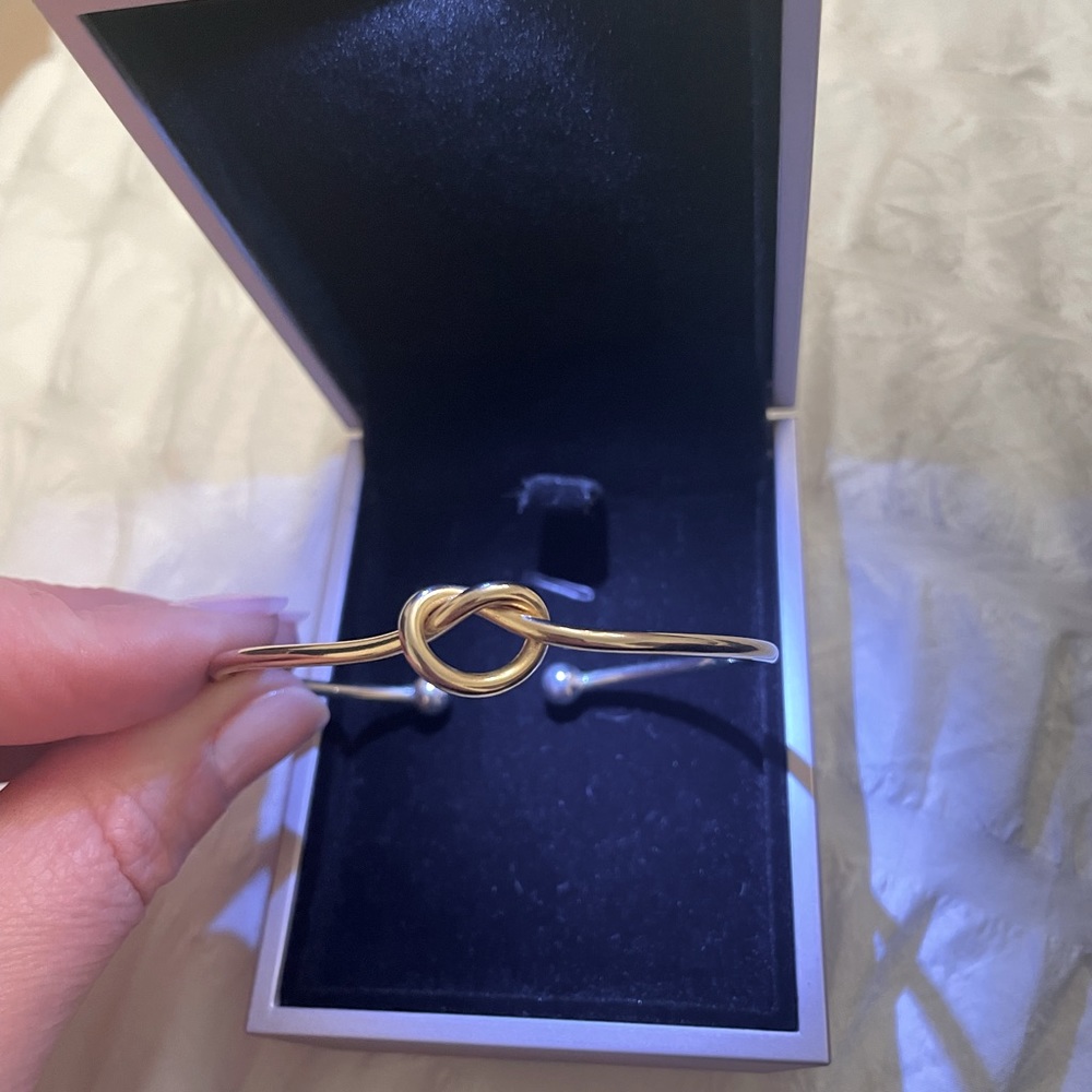 Gold plated knot bangle.